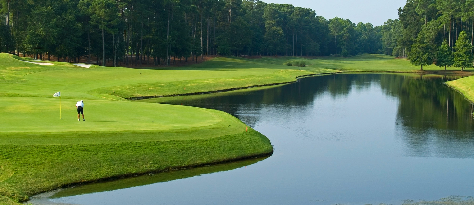 Wooded golf links with water hazard